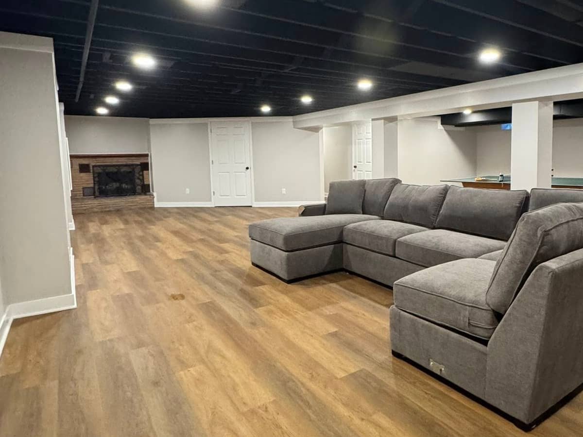 basement renovation with new couch and flooring