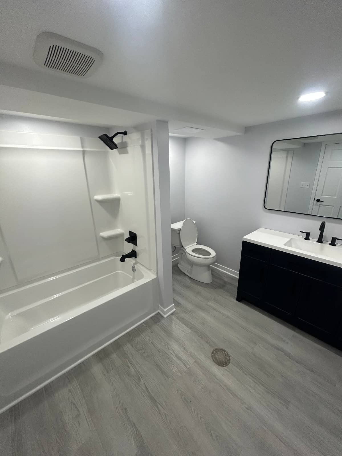 full bathroom remodel with new flooring and cabinets