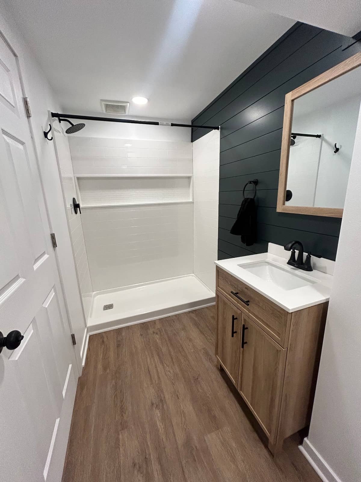 bathroom remodel with white and green tones