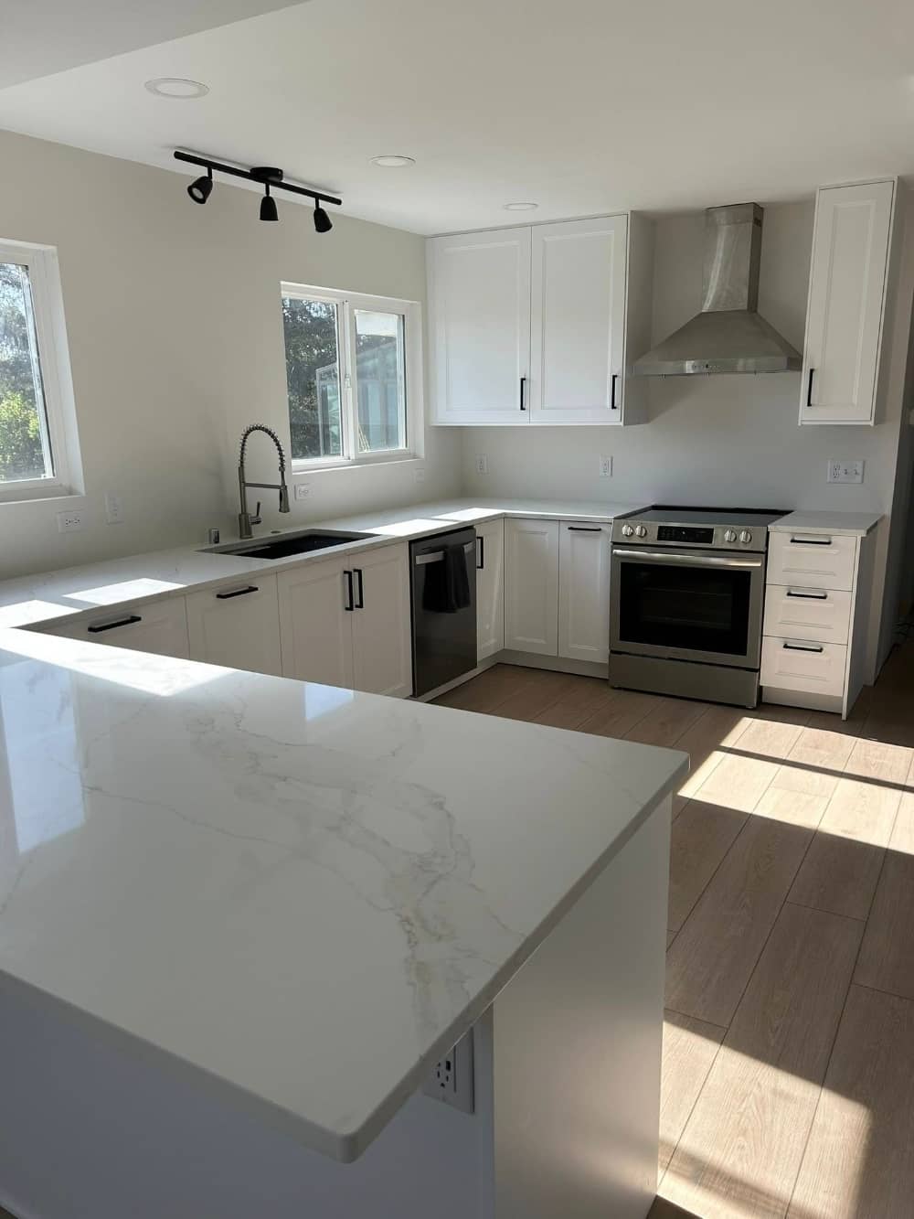 kitchen remodeling project with new marble countertops and white cabinets